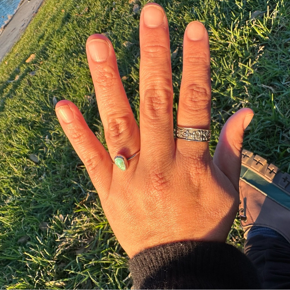 Vintage silver ring with raised floral motif, with beautiful patina.